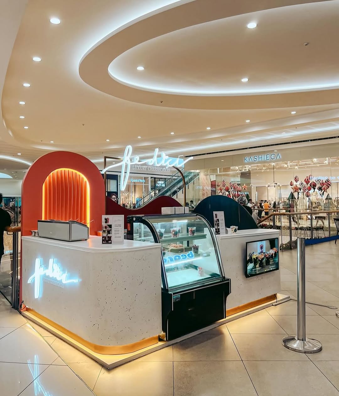 Fédici SM Mall of Asia kiosk — neon sign and cheesecake display
